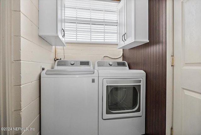 laundry room with cabinets and washer and clothes dryer