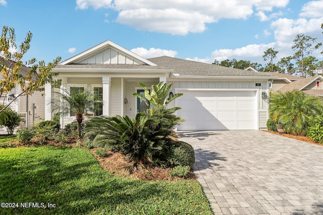 view of front facade with a front lawn and a garage