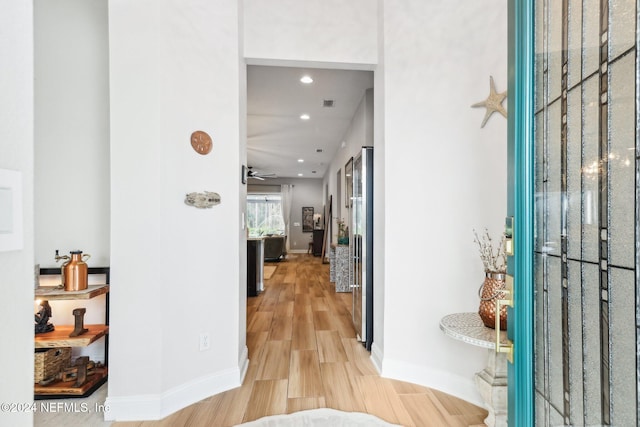 corridor with light hardwood / wood-style flooring