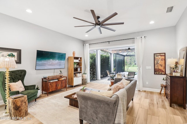 living room featuring light hardwood / wood-style floors and ceiling fan