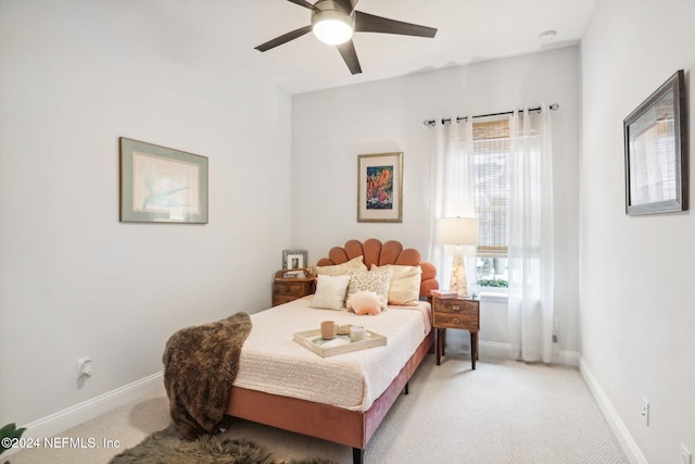 bedroom with light carpet, multiple windows, and ceiling fan