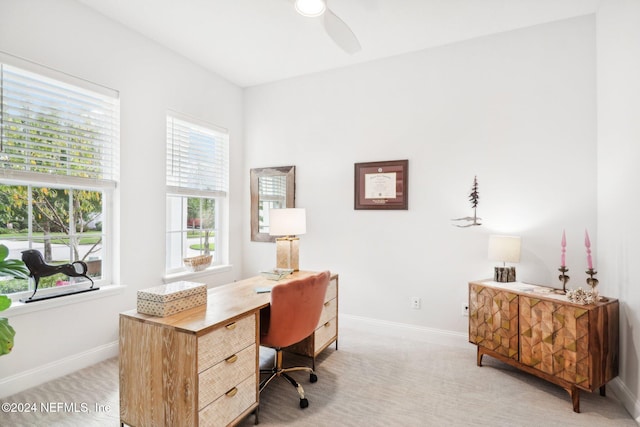 carpeted office space with ceiling fan