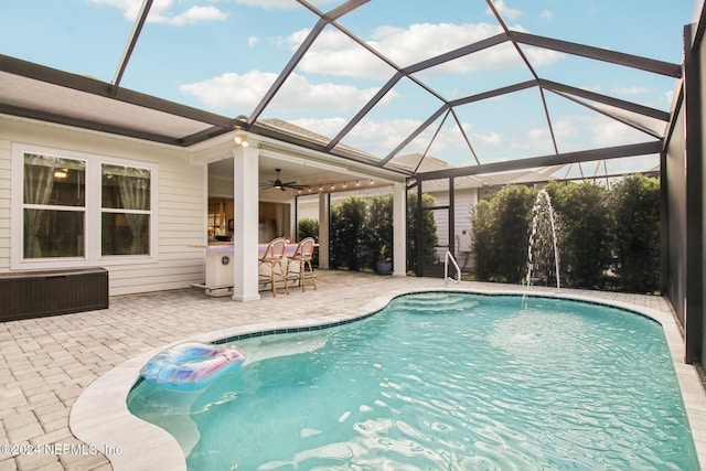 view of pool with a lanai, ceiling fan, and a patio area