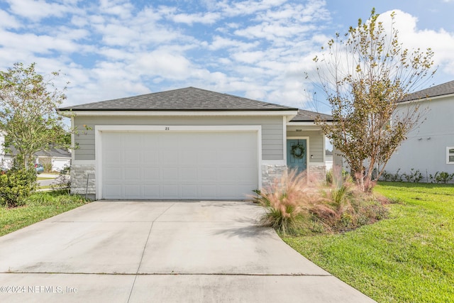 view of front facade featuring a front yard and a garage