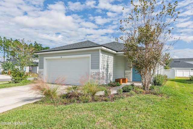 view of front of home featuring a front yard and a garage