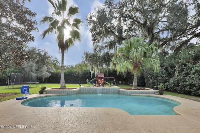 view of pool with a playground, a trampoline, and a lawn