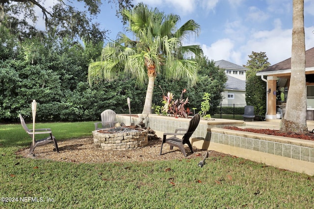 view of yard with a fire pit