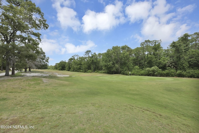 view of property's community with a lawn