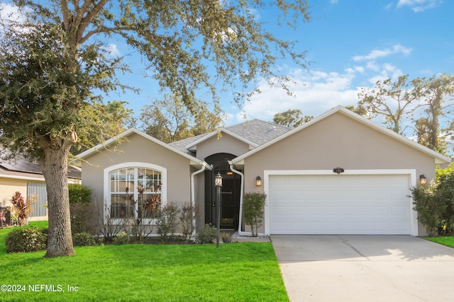 single story home with a front yard and a garage