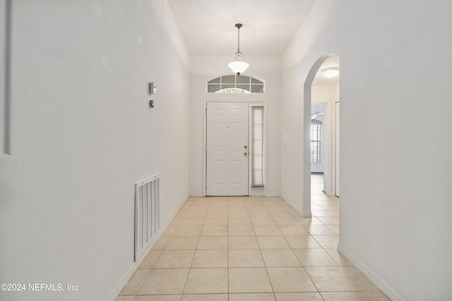 entrance foyer with plenty of natural light and light tile patterned flooring