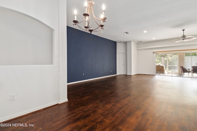 empty room with dark hardwood / wood-style floors and ceiling fan with notable chandelier