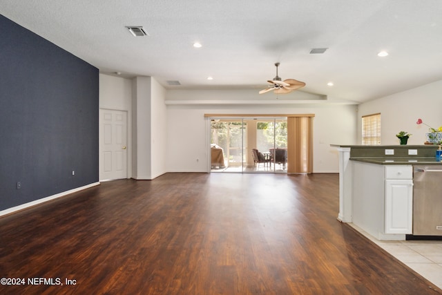 unfurnished living room featuring a textured ceiling, vaulted ceiling, light hardwood / wood-style flooring, and ceiling fan