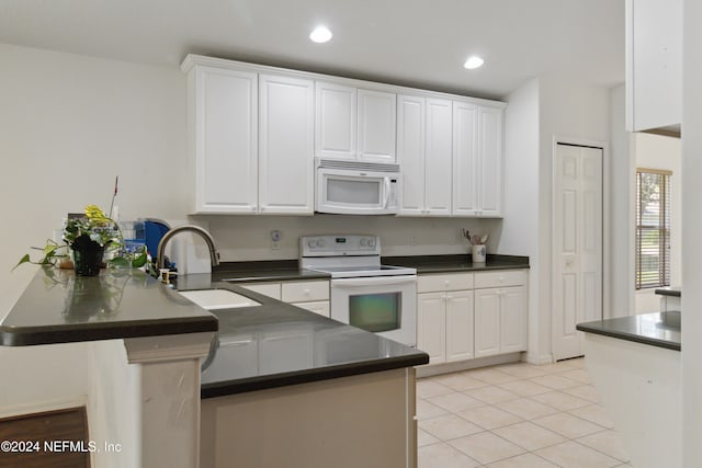 kitchen with white cabinetry, sink, kitchen peninsula, white appliances, and light tile patterned floors