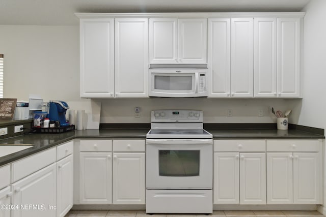 kitchen featuring white cabinets, white appliances, and light tile patterned flooring