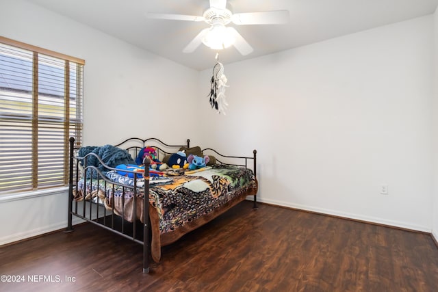 bedroom with wood finished floors, baseboards, and a ceiling fan
