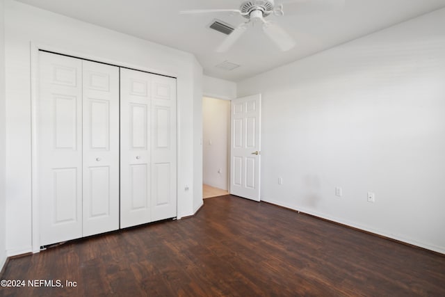 unfurnished bedroom featuring a closet, ceiling fan, and dark hardwood / wood-style flooring