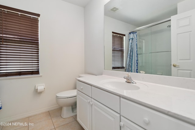 full bath featuring a shower with curtain, tile patterned floors, toilet, baseboards, and vanity