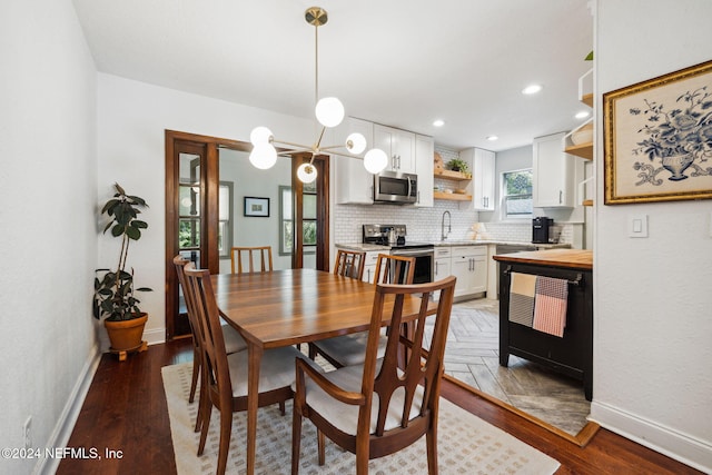 dining space featuring hardwood / wood-style floors and sink