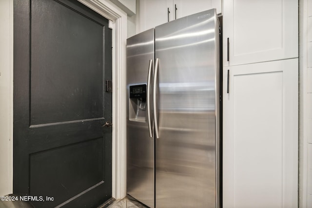 kitchen with white cabinets and stainless steel fridge with ice dispenser