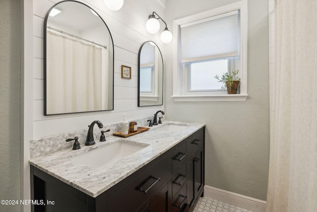 bathroom featuring wooden walls and vanity