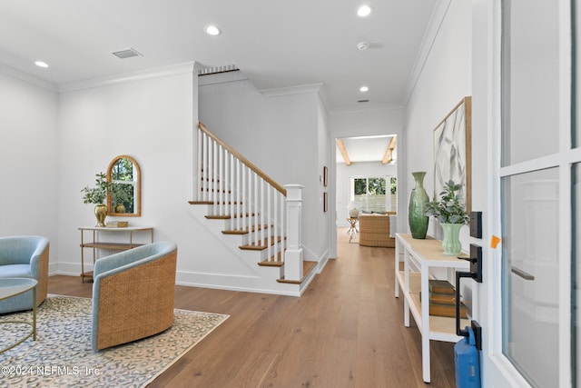 entrance foyer with wood-type flooring and ornamental molding