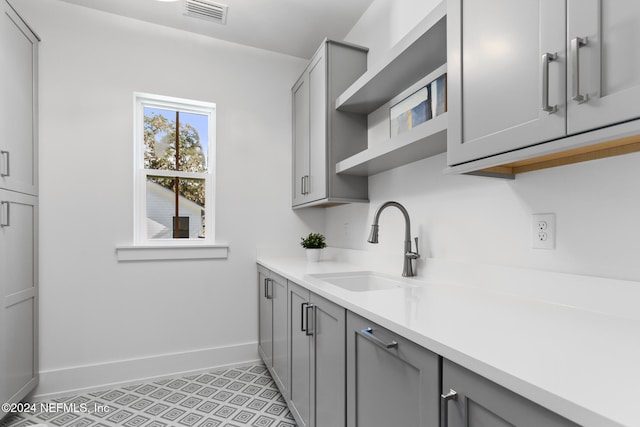 kitchen with gray cabinets and sink