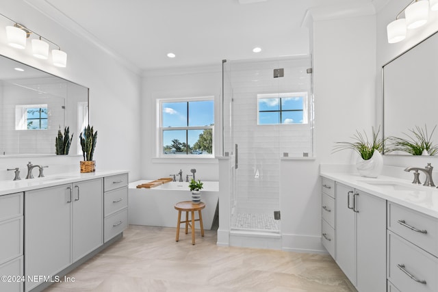 bathroom with vanity, crown molding, and independent shower and bath