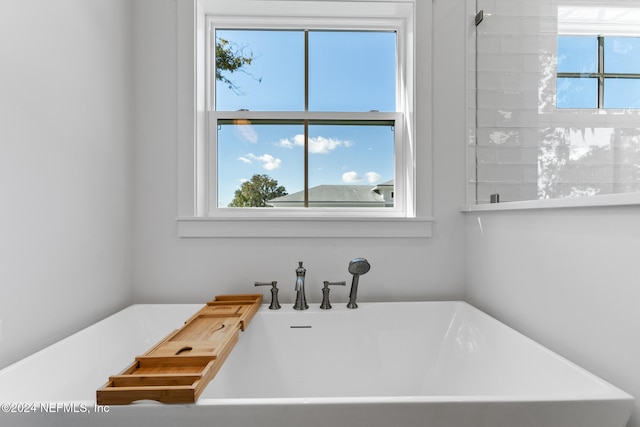 bathroom with a tub to relax in