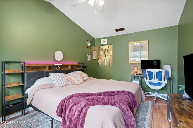 bedroom with wood-type flooring, ceiling fan, and lofted ceiling