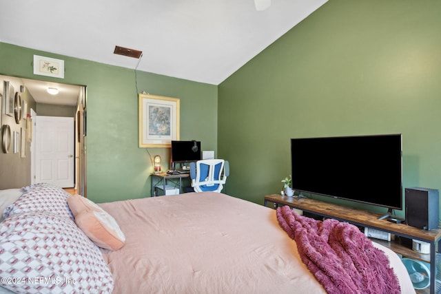 bedroom with hardwood / wood-style floors and vaulted ceiling