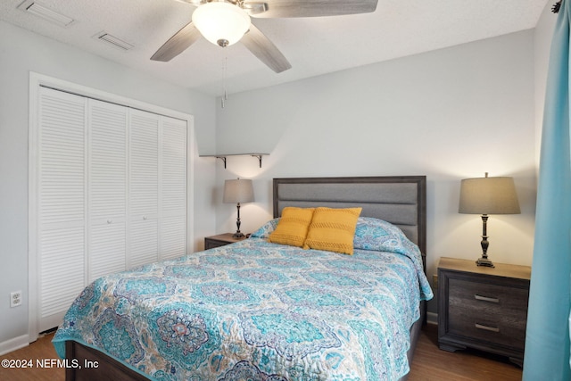 bedroom with ceiling fan, a closet, and hardwood / wood-style flooring