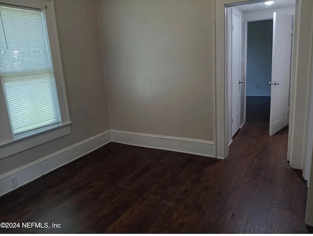 spare room featuring dark hardwood / wood-style flooring