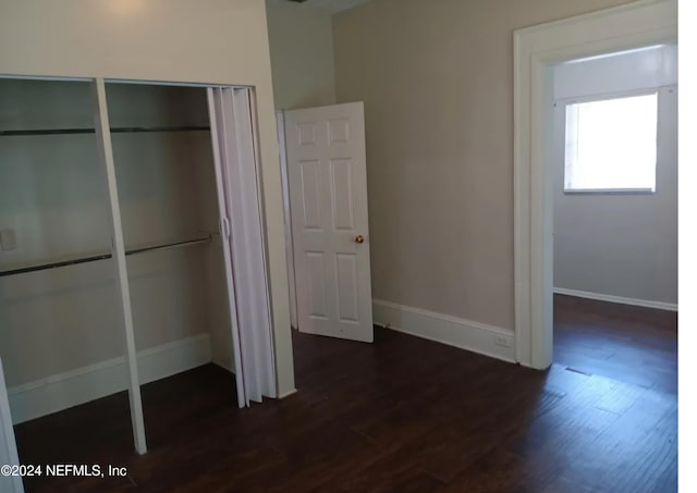 unfurnished bedroom featuring dark hardwood / wood-style floors