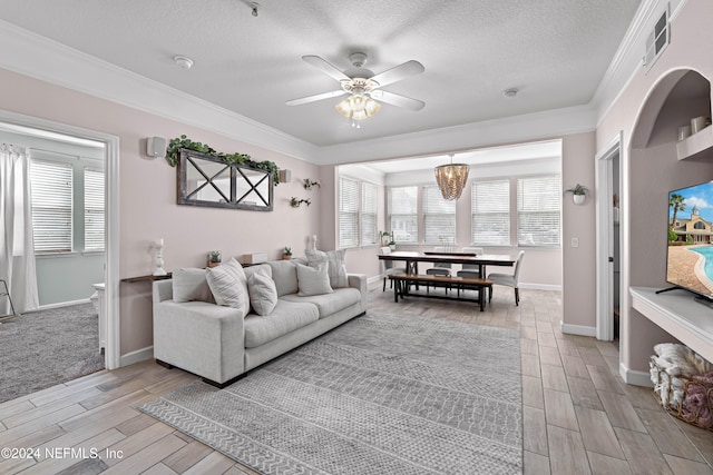 living room with a textured ceiling, light hardwood / wood-style flooring, ceiling fan, and ornamental molding