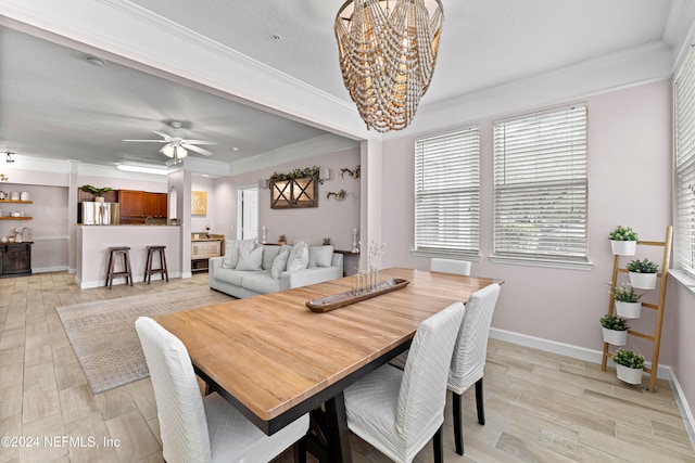 dining room featuring ceiling fan with notable chandelier, light hardwood / wood-style floors, and crown molding