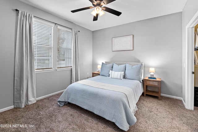 carpeted bedroom featuring ceiling fan and multiple windows