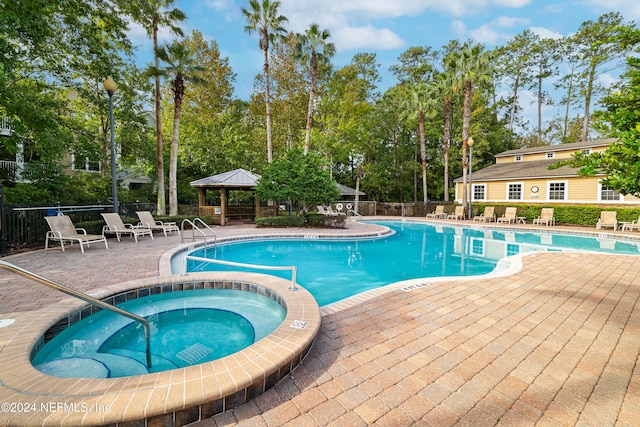 view of swimming pool featuring a gazebo, a patio, and a hot tub