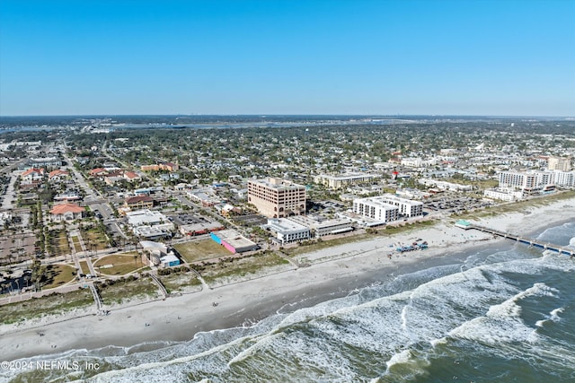 aerial view with a water view and a view of the beach