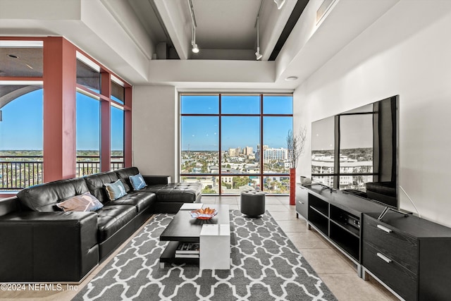 living room with light tile patterned floors and a high ceiling