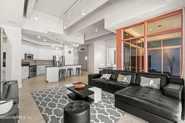 living room with light tile patterned floors and a towering ceiling