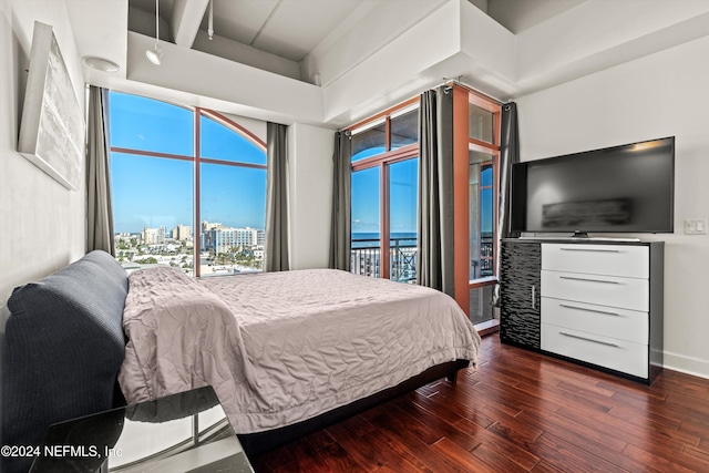 bedroom with access to exterior and dark hardwood / wood-style floors