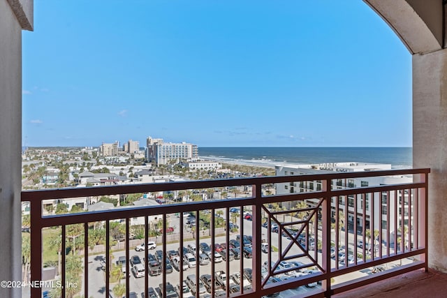 balcony with a water view and a beach view