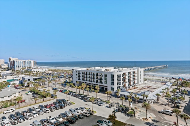 birds eye view of property with a water view and a beach view