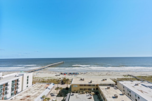 birds eye view of property featuring a water view and a beach view