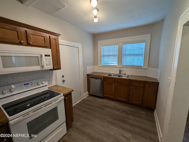 kitchen with sink, stainless steel dishwasher, dark hardwood / wood-style floors, electric stove, and decorative backsplash