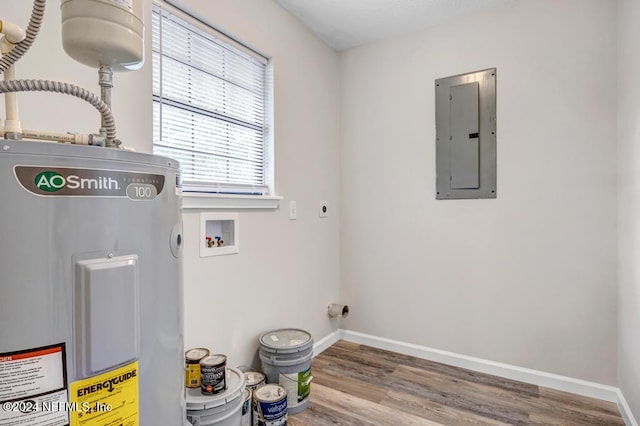 laundry room with hookup for an electric dryer, washer hookup, water heater, hardwood / wood-style floors, and electric panel