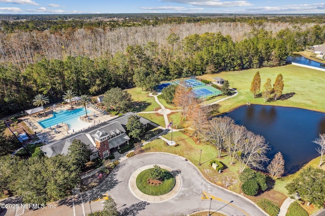 aerial view with a water view and a wooded view