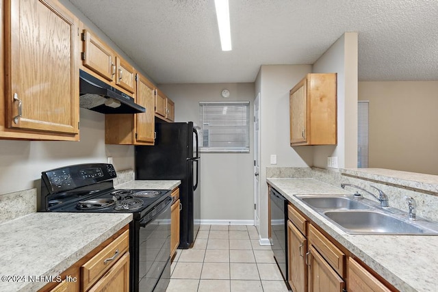 kitchen with sink, light tile patterned floors, black appliances, and a textured ceiling