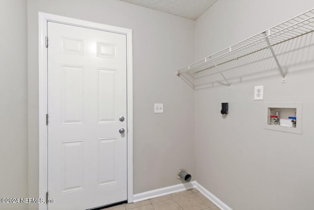 laundry room with hookup for a washing machine and light tile patterned flooring