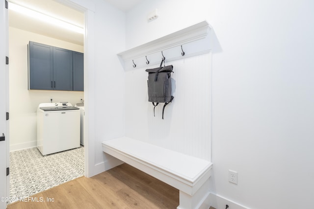 mudroom with washing machine and dryer and light hardwood / wood-style floors